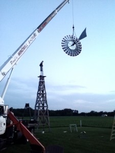 Lifting windmill onto wood tower    